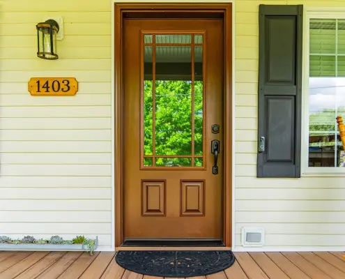 Covered front porch with wood-look fiberglass front door