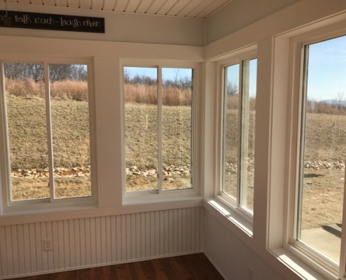 looking out the windows of a sunroom