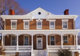 full front of house featuring white gingerbread trim