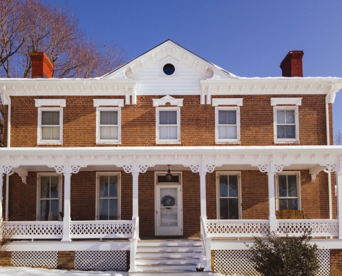 full front of house featuring white gingerbread trim