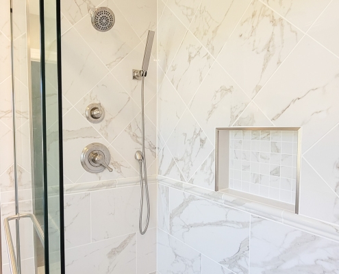 Klimovich bathroom remodel shower that features custom shampoo niche.