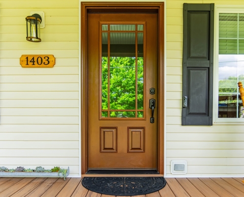Covered front porch with wood-look fiberglass front door