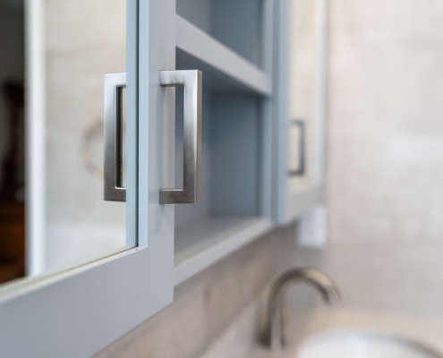 Custom cabinetry and close up of hardware in a spa-worthy bathroom renovation.