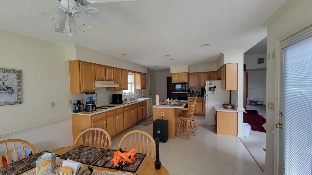 image5 Rockingham kitchen before a kitchen remodel with white countertops and honey oak cabinetry.