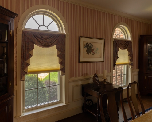 An interior parlor room with replacement windows.
