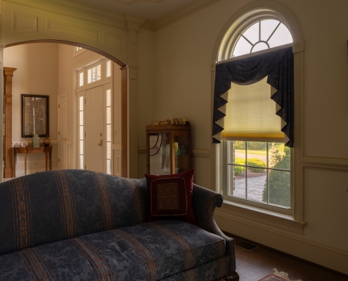 An interior parlor room with replacement windows.