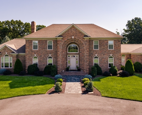 A Bridgewater home with replacement windows and a front walkway.